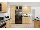 Kitchen boasting stainless steel appliances, custom cabinetry, and tiled floors at 5197 S Perry St, Littleton, CO 80123