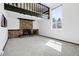 Cozy living room featuring a stone fireplace and large windows for ample natural light at 5197 S Perry St, Littleton, CO 80123