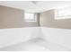 Partially finished basement with wainscoting, a window, and freshly painted walls at 620 Clermont St, Denver, CO 80220