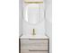 Modern bathroom featuring a round mirror, light wood vanity and a gold faucet at 620 Clermont St, Denver, CO 80220