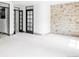 Spacious bedroom with stone accent wall, unique doors, and a walk-in closet at 620 Clermont St, Denver, CO 80220