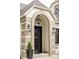 Detailed view of the home's front door, arched entryway, and classic exterior lighting at 620 Clermont St, Denver, CO 80220