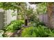 Tranquil garden featuring lush ferns, vibrant greenery, and a charming stone water feature at 620 Clermont St, Denver, CO 80220