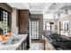 Gourmet kitchen featuring marble countertops, dark wood cabinets, and stainless appliances at 620 Clermont St, Denver, CO 80220