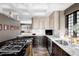 Spacious kitchen featuring a large island, marble counters, and ample storage at 620 Clermont St, Denver, CO 80220