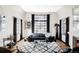 Living room with large window, modern black and white rug, and stylish furnishings at 620 Clermont St, Denver, CO 80220