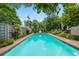 Beautiful in-ground pool surrounded by lush landscaping and a private fence, perfect for relaxation at 620 Clermont St, Denver, CO 80220