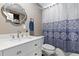 Charming bathroom with elegant mirror and vanity, and a blue and white patterned shower curtain at 6502 W 96Th Ave, Westminster, CO 80021