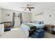 Comfortable bedroom with a ceiling fan and a bed with a blue comforter, next to a window at 6502 W 96Th Ave, Westminster, CO 80021