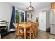 Cozy dining room with a wood table, chairs, and natural light from the large window at 6502 W 96Th Ave, Westminster, CO 80021