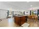 Open-concept design with kitchen island that has bar stool seating, living room, and dining room at 6502 W 96Th Ave, Westminster, CO 80021