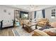 Cozy living room with a ceiling fan, large television, an entertainment center, and a comfortable beige couch at 6502 W 96Th Ave, Westminster, CO 80021