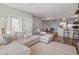 Cozy living room with neutral decor, an open floor plan, and access to the kitchen and outdoor space at 210 S Cherrywood Dr # 303, Lafayette, CO 80026
