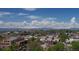 Expansive aerial view of the city, displaying neighborhood with mountain views on a sunny day with blue sky at 2650 W Front View Crescent Dr # 101, Denver, CO 80211