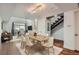 Bright dining room with modern table set, hardwood floors, and a view into the living area at 2650 W Front View Crescent Dr # 101, Denver, CO 80211