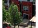 Modern exterior features a red brick facade, large windows, and a well-maintained green tree in front at 2650 W Front View Crescent Dr # 101, Denver, CO 80211