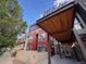 Exterior view of modern building featuring covered entryway, red facade, and large windows at 2650 W Front View Crescent Dr # 101, Denver, CO 80211