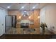Modern kitchen featuring granite countertops, stainless steel appliances, and a central island at 2650 W Front View Crescent Dr # 101, Denver, CO 80211