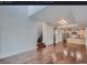 Spacious living area with hardwood floors, open floor plan, modern lighting and kitchen access at 2650 W Front View Crescent Dr # 101, Denver, CO 80211
