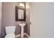 Stylish powder room boasts pedestal sink with decorative mirror and fixtures at 2650 W Front View Crescent Dr # 101, Denver, CO 80211