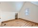 Bright and airy attic space featuring wood floors and a window that provides natural light at 160 W Bayaud Ave, Denver, CO 80223