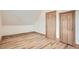Bedroom features wood laminate flooring, neutral paint and two wood paneled doors at 160 W Bayaud Ave, Denver, CO 80223