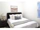 Cozy bedroom with a comfortable bed, soft bedding, and a serene atmosphere with natural light from the window at 160 W Bayaud Ave, Denver, CO 80223