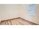 Bedroom featuring a window with blinds and new wood flooring at 160 W Bayaud Ave, Denver, CO 80223