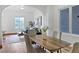Bright dining room with seating for four, hardwood floors and a large window at 160 W Bayaud Ave, Denver, CO 80223