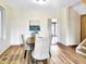 Light-filled dining room boasts hardwood floors, neutral decor, and modern artwork on the wall at 160 W Bayaud Ave, Denver, CO 80223