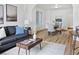 Open-concept living room and dining area with hardwood floors, neutral decor and plenty of light at 160 W Bayaud Ave, Denver, CO 80223