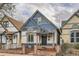 Quaint blue and white two-story home featuring unique architectural details and a welcoming front porch at 160 W Bayaud Ave, Denver, CO 80223
