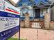 Home for sale, close up of front of home with beautiful garden area and porch at 160 W Bayaud Ave, Denver, CO 80223