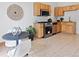 Bright kitchen featuring wood cabinets, stainless steel appliances, and dining area with a modern table and chairs at 160 W Bayaud Ave, Denver, CO 80223