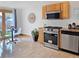 Modern kitchen with stainless steel appliances, tile flooring, and plenty of counter space at 160 W Bayaud Ave, Denver, CO 80223