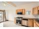 Bright kitchen features stainless steel appliances, granite counters, and wood cabinets at 160 W Bayaud Ave, Denver, CO 80223