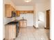 Kitchen featuring wooden cabinets, stainless steel appliances, granite counters, and tile flooring at 160 W Bayaud Ave, Denver, CO 80223