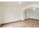 Spacious living room featuring hardwood floors, an arched doorway, and natural light, creating an open feel at 160 W Bayaud Ave, Denver, CO 80223