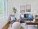 Bright living room features comfortable seating, decor, and a large window at 160 W Bayaud Ave, Denver, CO 80223