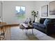 Cozy living room featuring a comfortable sofa, stylish decor, and plenty of natural light at 160 W Bayaud Ave, Denver, CO 80223