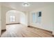 Bright living room featuring hardwood floors and an arched doorway offers a seamless flow to adjacent spaces at 160 W Bayaud Ave, Denver, CO 80223