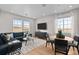 Inviting living room with large windows and modern decor featuring a comfortable seating area at 17112 W 91St Ln, Arvada, CO 80007