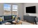 Comfortable living room with large windows providing views and modern decor at 17112 W 91St Ln, Arvada, CO 80007
