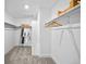 Functional walk-in closet with ample shelving, rods and storage space for organization at 17112 W 91St Ln, Arvada, CO 80007