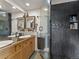 Modern bathroom features a double sink vanity with custom cabinets and a glass-enclosed shower with tile surround at 197 Sawmill Ln, Idaho Springs, CO 80452