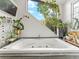 Soaking tub situated under a window with green plants offering views of nature and lots of natural light at 197 Sawmill Ln, Idaho Springs, CO 80452