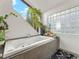 Tranquil bathtub with a view, surrounded by lush greenery and natural light from the unique windows at 197 Sawmill Ln, Idaho Springs, CO 80452
