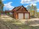 Unique mountain home featuring a two-car garage and bridge to a deck with scenic views at 197 Sawmill Ln, Idaho Springs, CO 80452