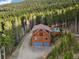 Beautiful mountain home featuring two car garage, balcony, and surrounded by lush forest at 197 Sawmill Ln, Idaho Springs, CO 80452