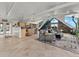Open-concept living room flowing into a modern kitchen, showcasing tiled floors and vaulted ceilings at 197 Sawmill Ln, Idaho Springs, CO 80452